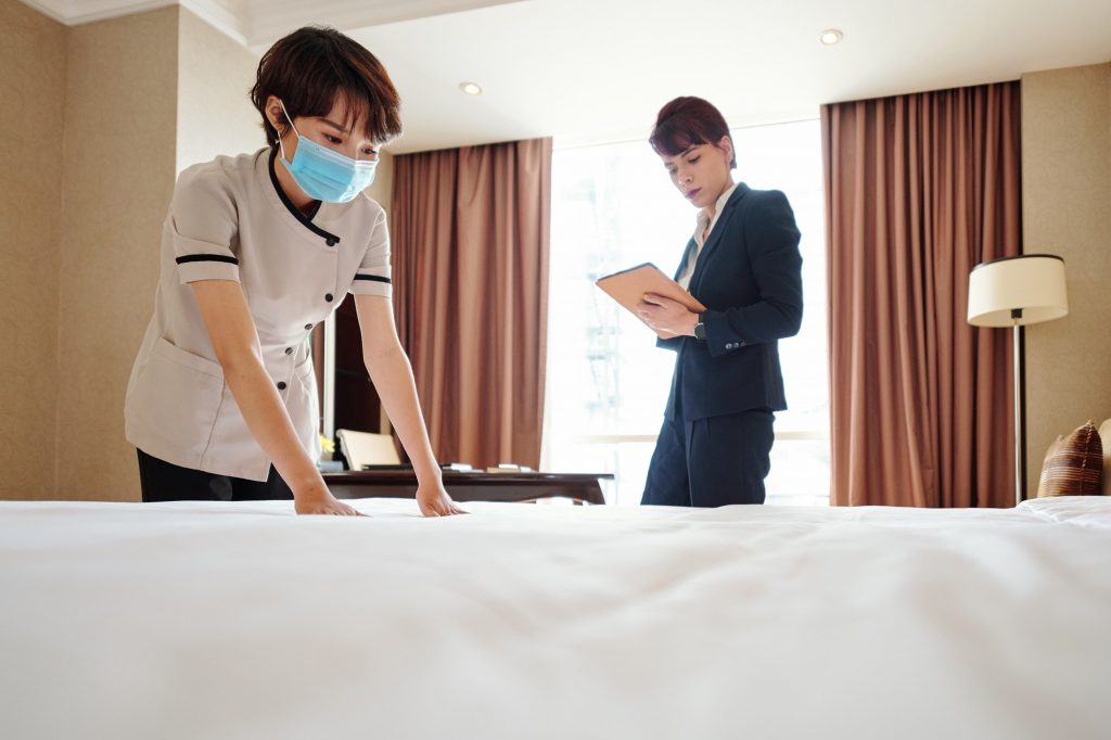 Maid making bed